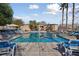 Community pool area with ample lounge chairs at 9048 Rich Amethyst Ct, Las Vegas, NV 89149