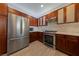 Modern kitchen with stainless steel appliances and wood cabinets at 9048 Rich Amethyst Ct, Las Vegas, NV 89149