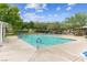 Community swimming pool with lounge chairs at 9048 Rich Amethyst Ct, Las Vegas, NV 89149