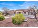 Large backyard with patio, gravel landscaping, and mature shrubs at 9308 Cactus Wood Dr, Las Vegas, NV 89134