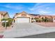 Front view of a single-story house with a garage and driveway at 9308 Cactus Wood Dr, Las Vegas, NV 89134