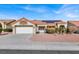 Single-story house with solar panels and a two-car garage at 9308 Cactus Wood Dr, Las Vegas, NV 89134