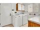 Laundry room with washer, dryer, and built-in cabinets at 9308 Cactus Wood Dr, Las Vegas, NV 89134