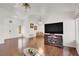 Living area with hardwood floors and a large TV at 9308 Cactus Wood Dr, Las Vegas, NV 89134