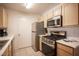 Modern kitchen with stainless steel appliances and light wood cabinets at 950 Seven Hills Dr # 2017, Henderson, NV 89052