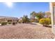 Large backyard with gravel and mature desert landscaping at 9921 Heyfield Dr, Las Vegas, NV 89134