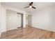 Bedroom with sliding door closet and wood-look floors at 9921 Heyfield Dr, Las Vegas, NV 89134