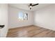 Bright bedroom with wood-look floors and ceiling fan at 9921 Heyfield Dr, Las Vegas, NV 89134