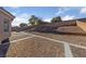Landscaped backyard with paved patio and retaining walls at 10229 Angels Loft St, Las Vegas, NV 89131