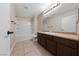 Clean bathroom with a shower/tub combo and wood vanity at 10229 Angels Loft St, Las Vegas, NV 89131