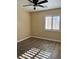 Bright bedroom featuring wood-look flooring, a ceiling fan, and window shutters at 10229 Angels Loft St, Las Vegas, NV 89131