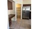 Kitchen features dark wood cabinets, a pantry, and stainless steel refrigerator at 10229 Angels Loft St, Las Vegas, NV 89131