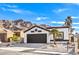 Front view of a remodeled home with desert landscaping and mountain views at 2276 Ray Kanel Dr, Las Vegas, NV 89156