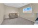 Cozy bedroom with neutral walls and a small sofa at 2314 Rock Slide Cir, Las Vegas, NV 89115