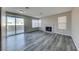 Spacious living room with gray walls, wood-look floors, and a fireplace at 2436 Millcroft Dr, Henderson, NV 89074