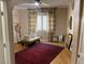 Well-lit bedroom with hardwood floor, window with shutters and red carpet at 2438 Ping Drive, Henderson, NV 89074