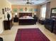 Large main bedroom with a dark wood bedroom set and red carpet at 2438 Ping Drive, Henderson, NV 89074
