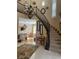 Elegant curved staircase with chandelier and view of dining area at 2438 Ping Drive, Henderson, NV 89074