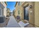 Entrance to a tan townhouse with a dark blue door and desert landscaping at 25 Barbara Ln # 42, Las Vegas, NV 89183