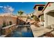 Luxury backyard oasis with a sparkling pool, water feature, and patio at 251 Castellari Dr, Las Vegas, NV 89138
