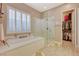 Relaxing bathroom with soaking tub, walk-in shower, and access to closet at 251 Castellari Dr, Las Vegas, NV 89138