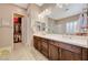 Elegant bathroom with double vanity, large mirror, and walk-in closet at 251 Castellari Dr, Las Vegas, NV 89138