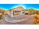 Private backyard with covered patio and desert landscaping at 2582 Evansville Ave, Henderson, NV 89052