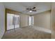 Spacious bedroom with a ceiling fan and access to a patio at 3024 Saint George St # H, North Las Vegas, NV 89030