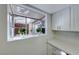 Kitchen features white cabinets, a window seat, and quartz countertops at 3024 Saint George St # H, North Las Vegas, NV 89030