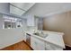Modern kitchen with white cabinets, stainless steel appliances, and a window at 3024 Saint George St # H, North Las Vegas, NV 89030