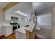 Eat-in kitchen with white cabinets, stainless steel appliances and a breakfast bar at 3024 Saint George St # H, North Las Vegas, NV 89030