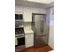 Modern kitchen with stainless steel appliances and white cabinets at 3024 Saint George St # H, North Las Vegas, NV 89030