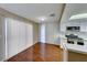 Eat-in kitchen with white cabinets and wood flooring at 3024 Saint George St # H, North Las Vegas, NV 89030