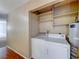 Laundry closet with washer, dryer, and shelving at 3024 Saint George St # H, North Las Vegas, NV 89030