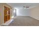 Spacious living room with carpeted floors and brick accent wall at 3024 Saint George St # H, North Las Vegas, NV 89030