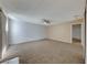 Large living room with brick wall and ceiling fan at 3024 Saint George St # H, North Las Vegas, NV 89030