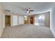 Living area with carpet, ceiling fan, and access to other rooms at 3024 Saint George St # H, North Las Vegas, NV 89030