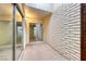 Private patio with sliding glass doors and brick walls at 3024 Saint George St # H, North Las Vegas, NV 89030