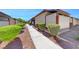 Landscaped walkway leading to apartment building entrance at 3024 Saint George St # H, North Las Vegas, NV 89030