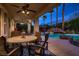 Relaxing covered patio with seating area, overlooking a sparkling pool and spa at 3042 Hammerwood Dr, Las Vegas, NV 89135