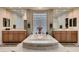 Spacious bathroom with double sinks, large bathtub, and glass block window at 3042 Hammerwood Dr, Las Vegas, NV 89135