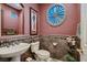Stylish powder room with unique round window and tile details at 3042 Hammerwood Dr, Las Vegas, NV 89135