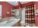 Clean bathroom with shower/tub combo and striped shower curtain at 3042 Hammerwood Dr, Las Vegas, NV 89135