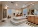 Spa-like bathroom with soaking tub, double vanities, and glass shower at 3042 Hammerwood Dr, Las Vegas, NV 89135