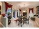 Bright breakfast nook with glass table and French doors leading to the patio at 3042 Hammerwood Dr, Las Vegas, NV 89135