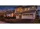 Elegant two-story home with a three-car garage and stone accents, set against a twilight sky at 3042 Hammerwood Dr, Las Vegas, NV 89135
