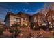 Charming home exterior featuring desert landscaping, stone accents, and a well-maintained yard at 3042 Hammerwood Dr, Las Vegas, NV 89135