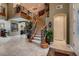 Elegant curved staircase with wrought iron railings and wood accents at 3042 Hammerwood Dr, Las Vegas, NV 89135