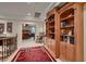 Elegant hallway with built-in wooden bookcase and red carpet runner at 3042 Hammerwood Dr, Las Vegas, NV 89135