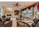 Relaxing living room with fireplace and large windows overlooking the pool at 3042 Hammerwood Dr, Las Vegas, NV 89135
